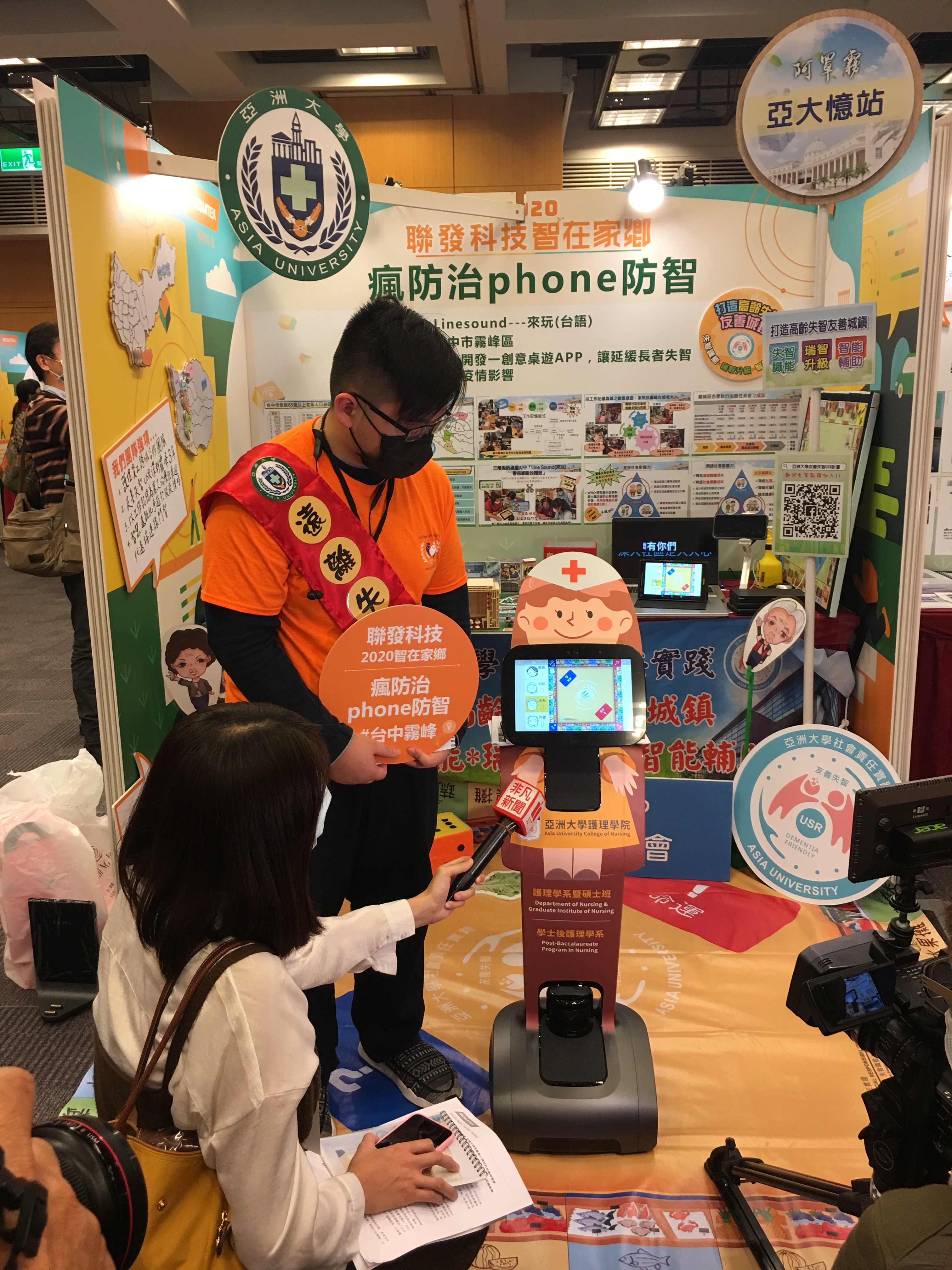 亞大護理學院TEMI機器人展示參賽作品「Line sound」App，吸引新聞媒體採訪。